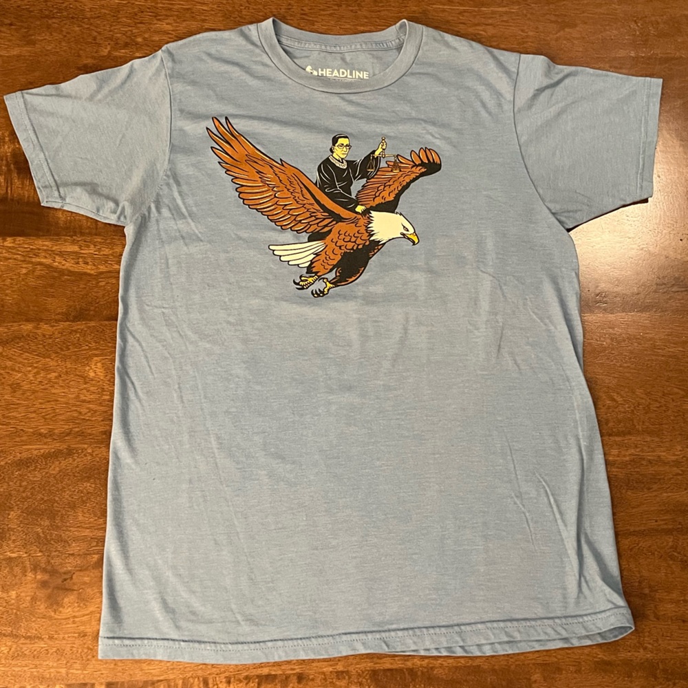 RBG Ruth Bader Ginsburg Flying Riding Eagle Light Blue Graphic Tee Shirt